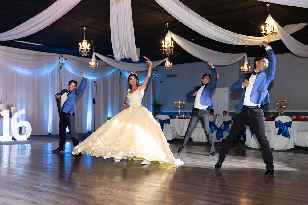 Quinceañera performing a choreographed surprise dance with her court. High-energy XV reception photography in Waukegan, IL.