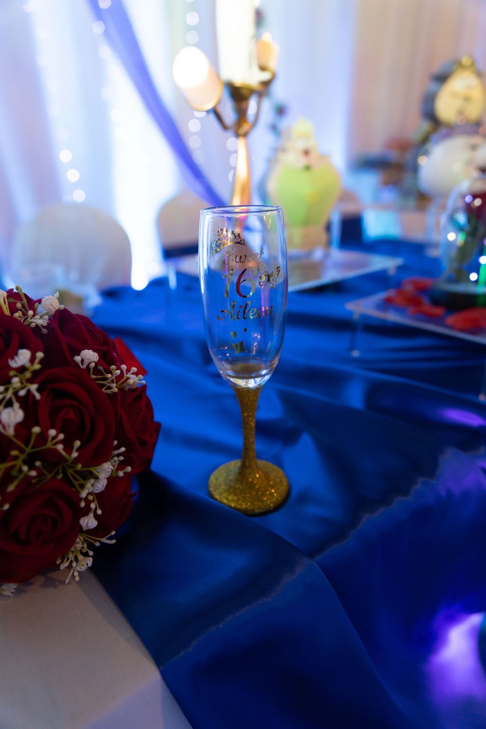 Royal blue and gold Quinceañera table centerpiece with candles. Elegant XV reception decor inspiration by Alex T Photography.