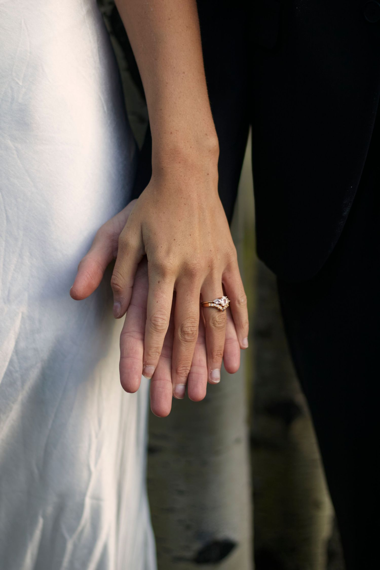 Wedding couple photography outdoor with soft light. Bride and groom holding hands.