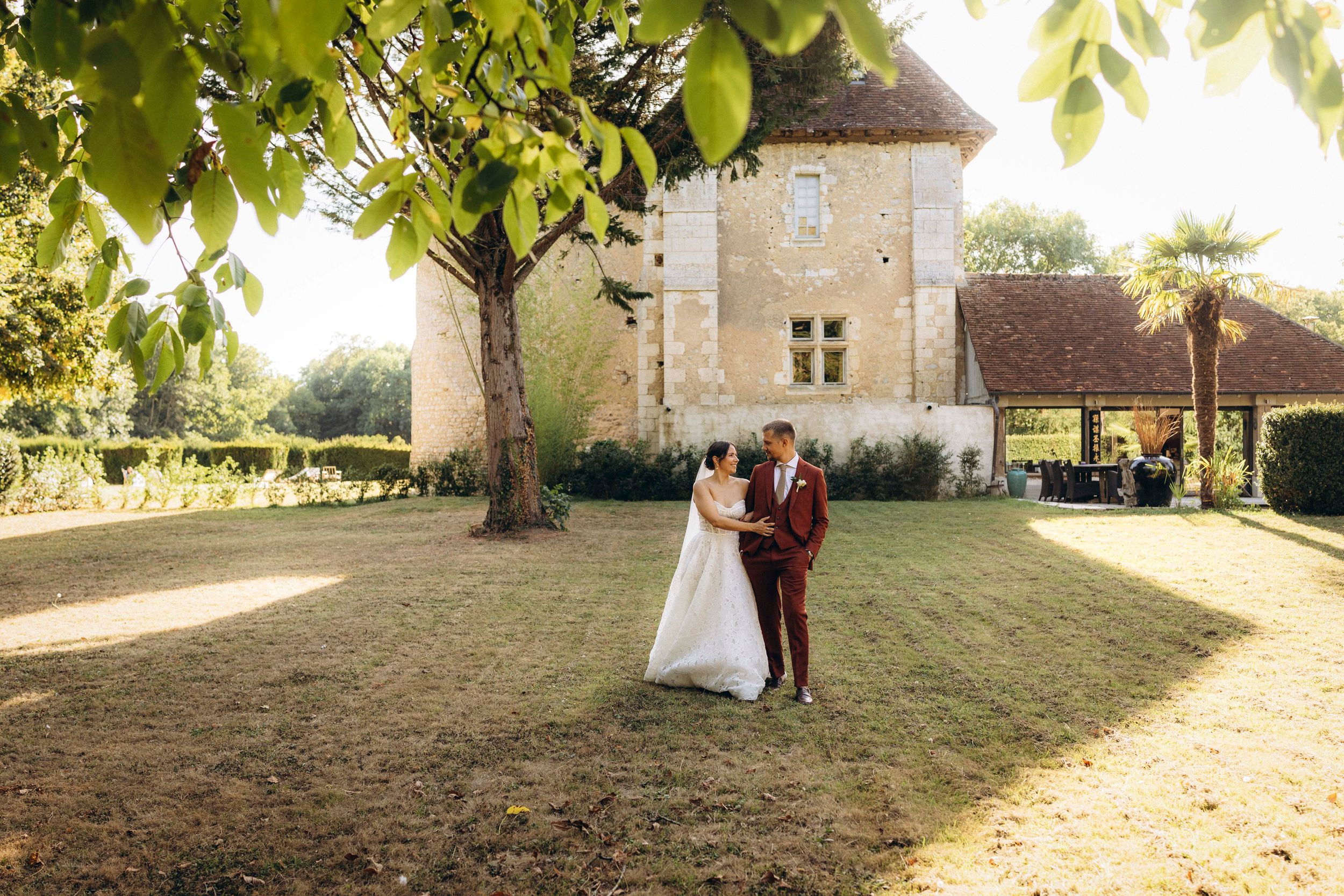 A romantic dance silhouette under stone archways with warm lighting.