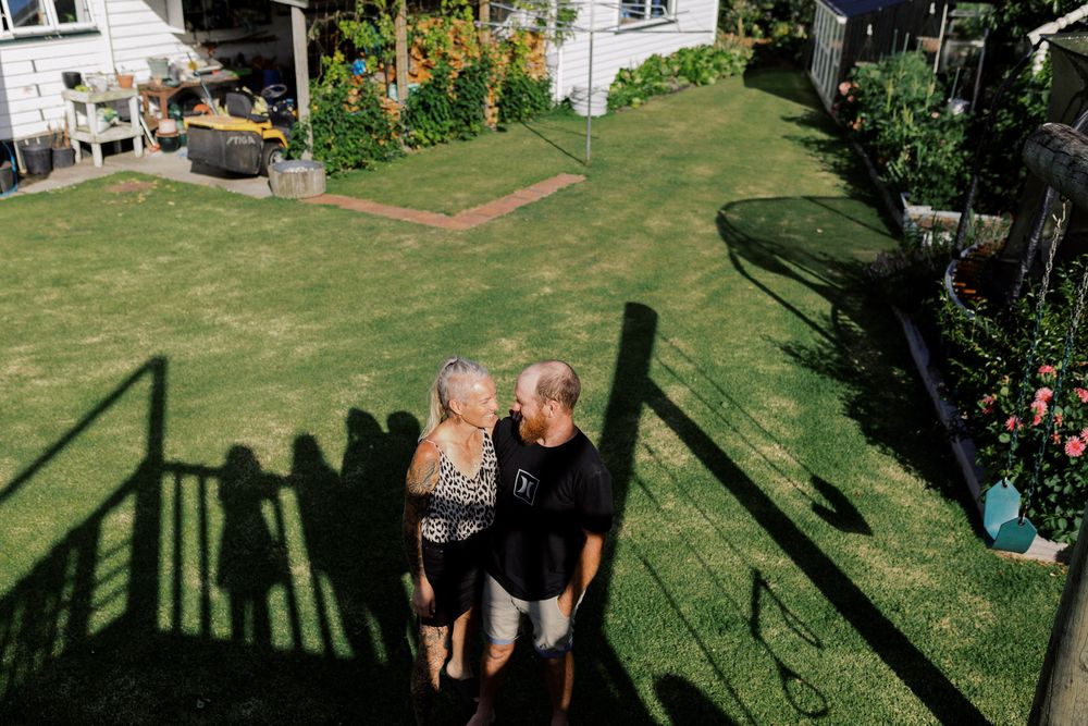 Shadows cast on green grass from figures enjoying a relaxing summer day outdoors.