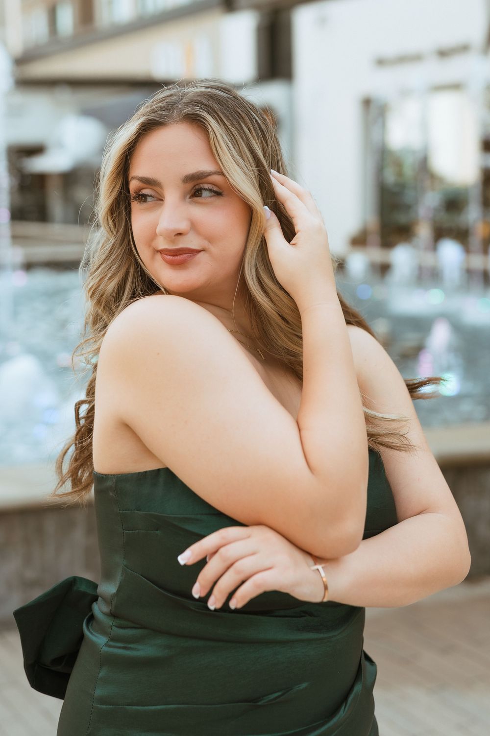 A portrait series shows close-up shots of a woman in an elegant dark green dress in various casual poses.