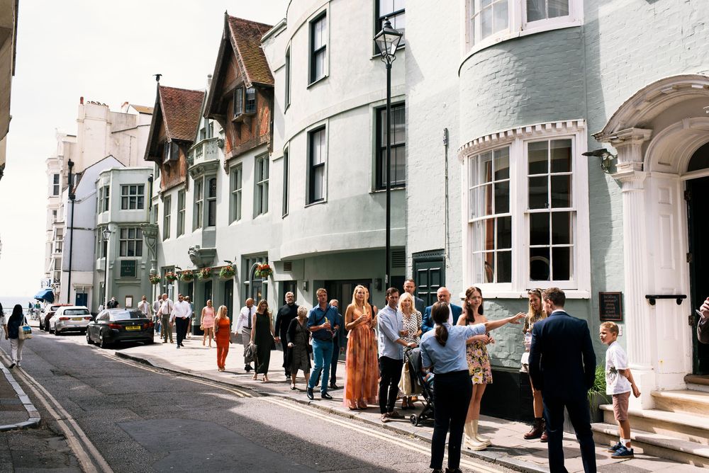 Guests gathering outside a charming Hotel Du Vin Brighton on a sunny wedding day.