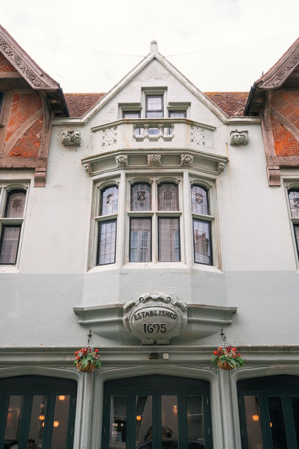 Historic Hotel Du Vin Brighton building facade established in 1695 with bay windows and ornate white architecture.