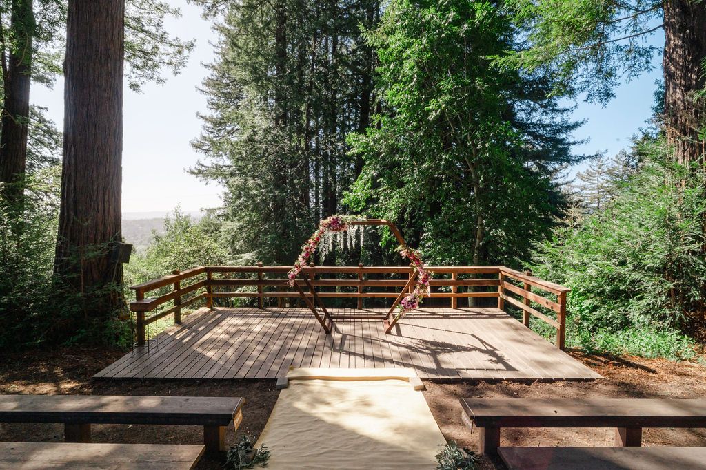 A rustic wooden boardwalk meanders through majestic redwood trees offering scenic views at Muir Woods National Monument.