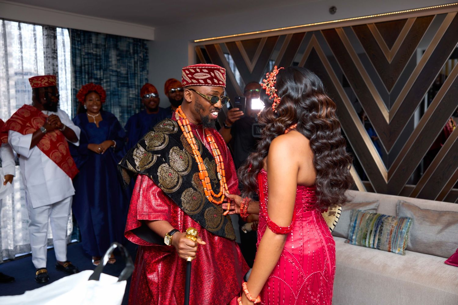 Traditional wedding ceremony setup with red and gold decor elements in an indoor venue.