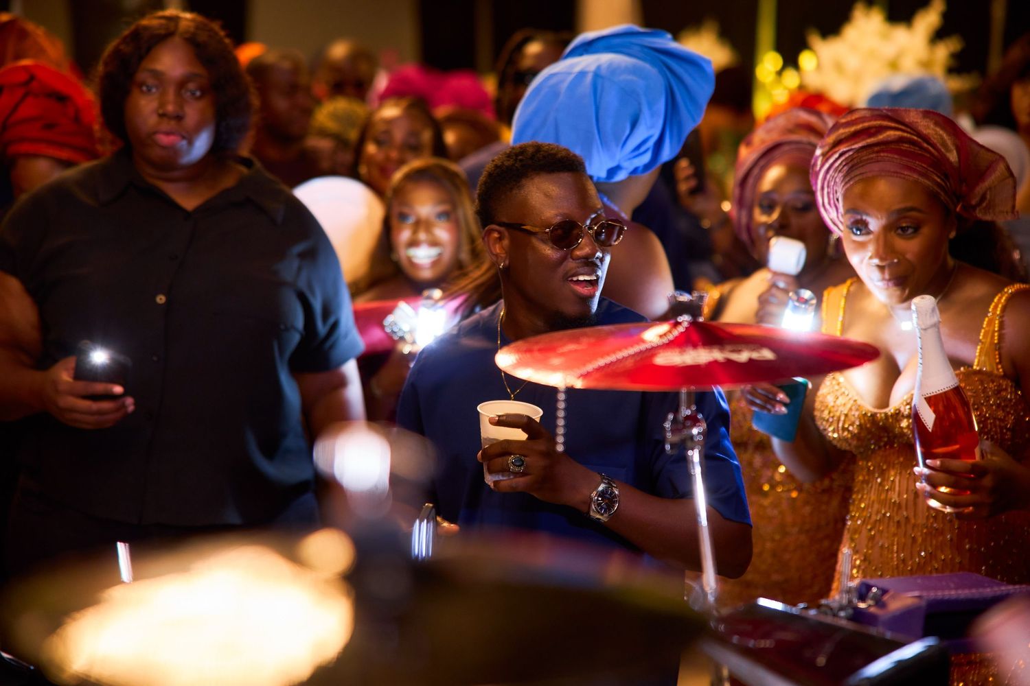People gathered in dimly lit spaces playing tabletop games and board games with friends across multiple gaming scenes.