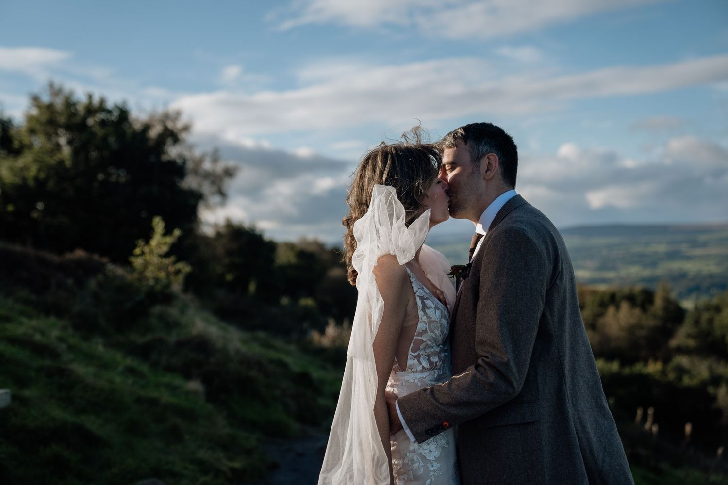 Couple kissing after eloping at Otley Chevin