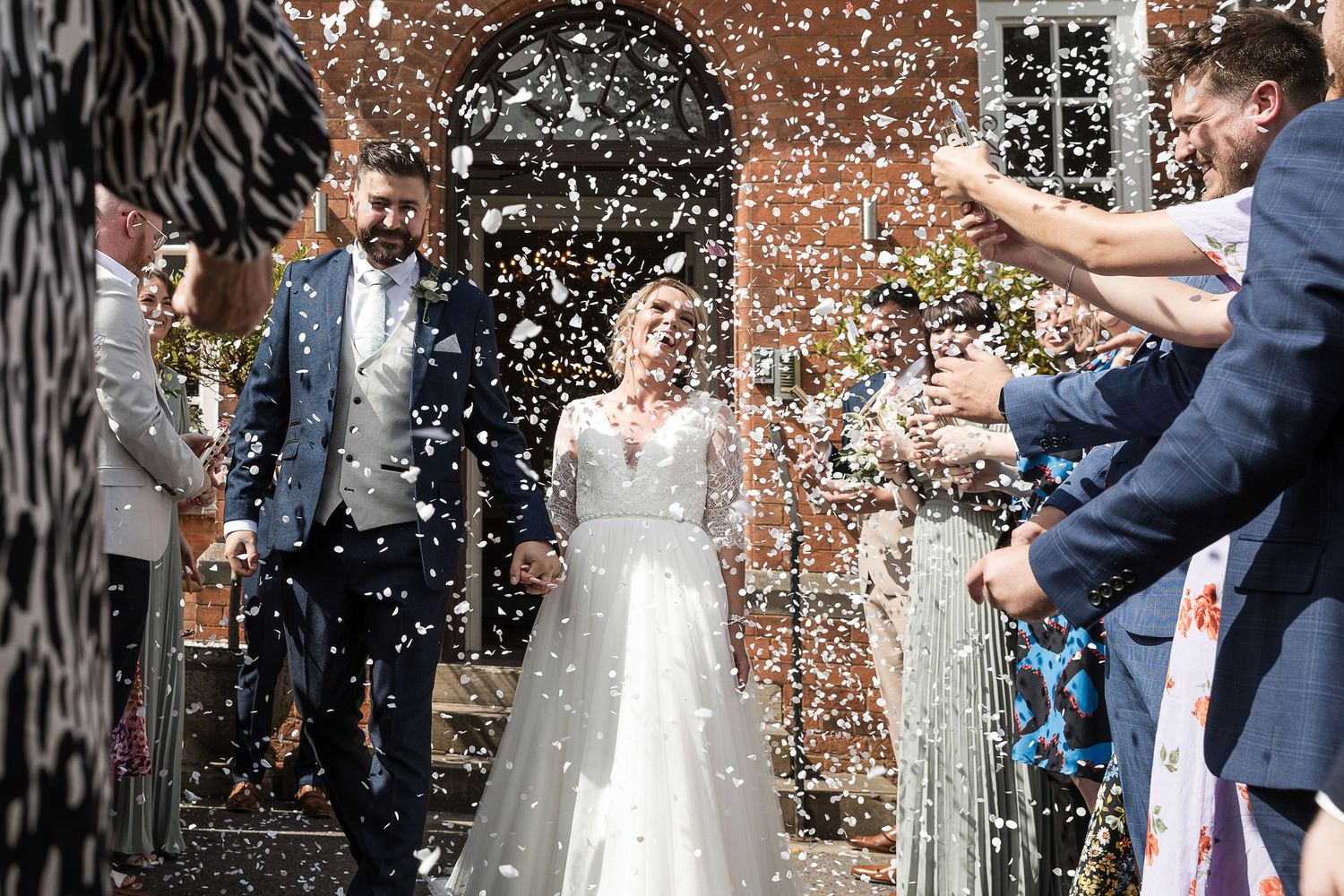 Bride & Groom at Kelham House, natural candid confetti photo.
