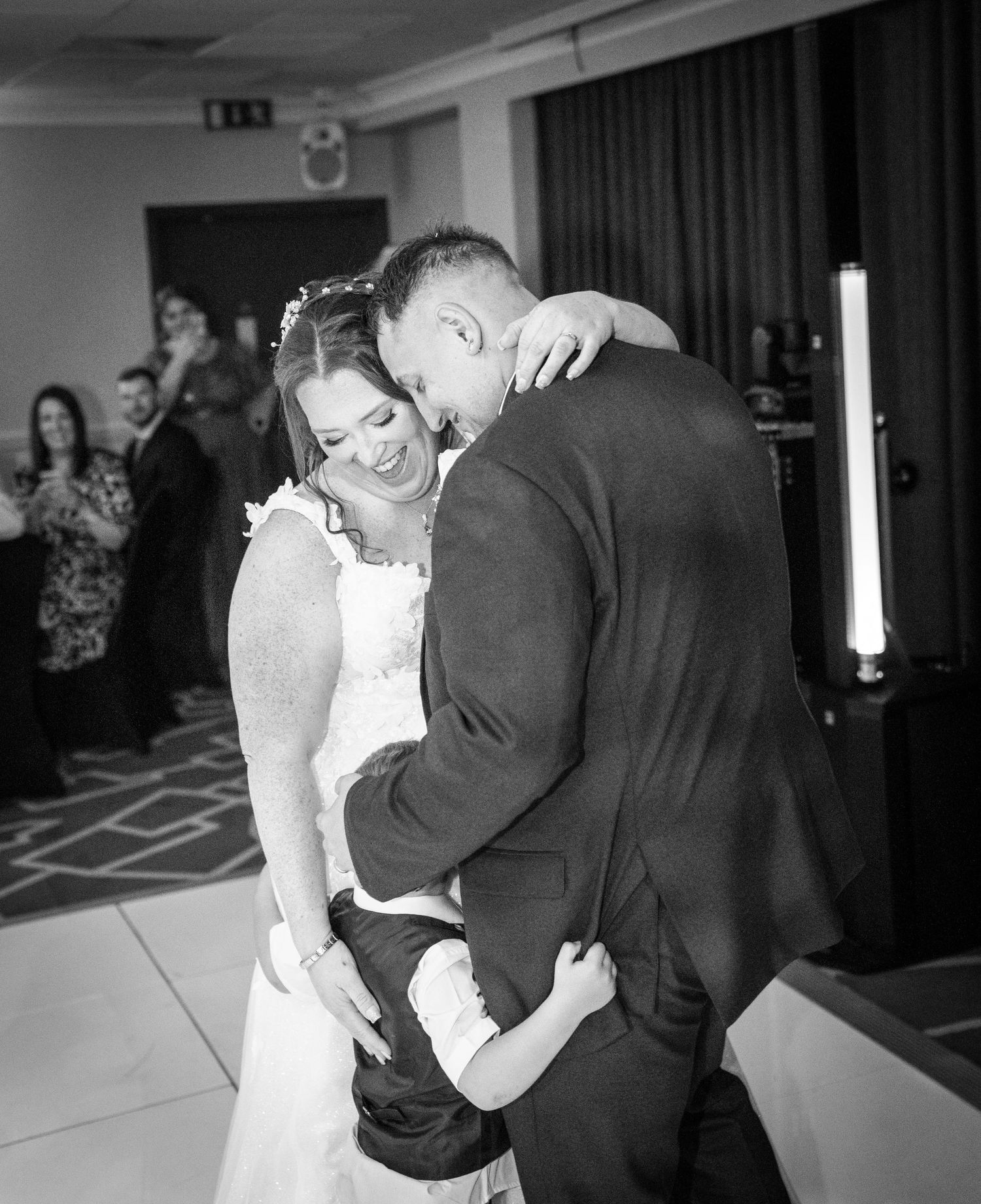 A romantic couple shares a tender moment during their first dance at their wedding reception.