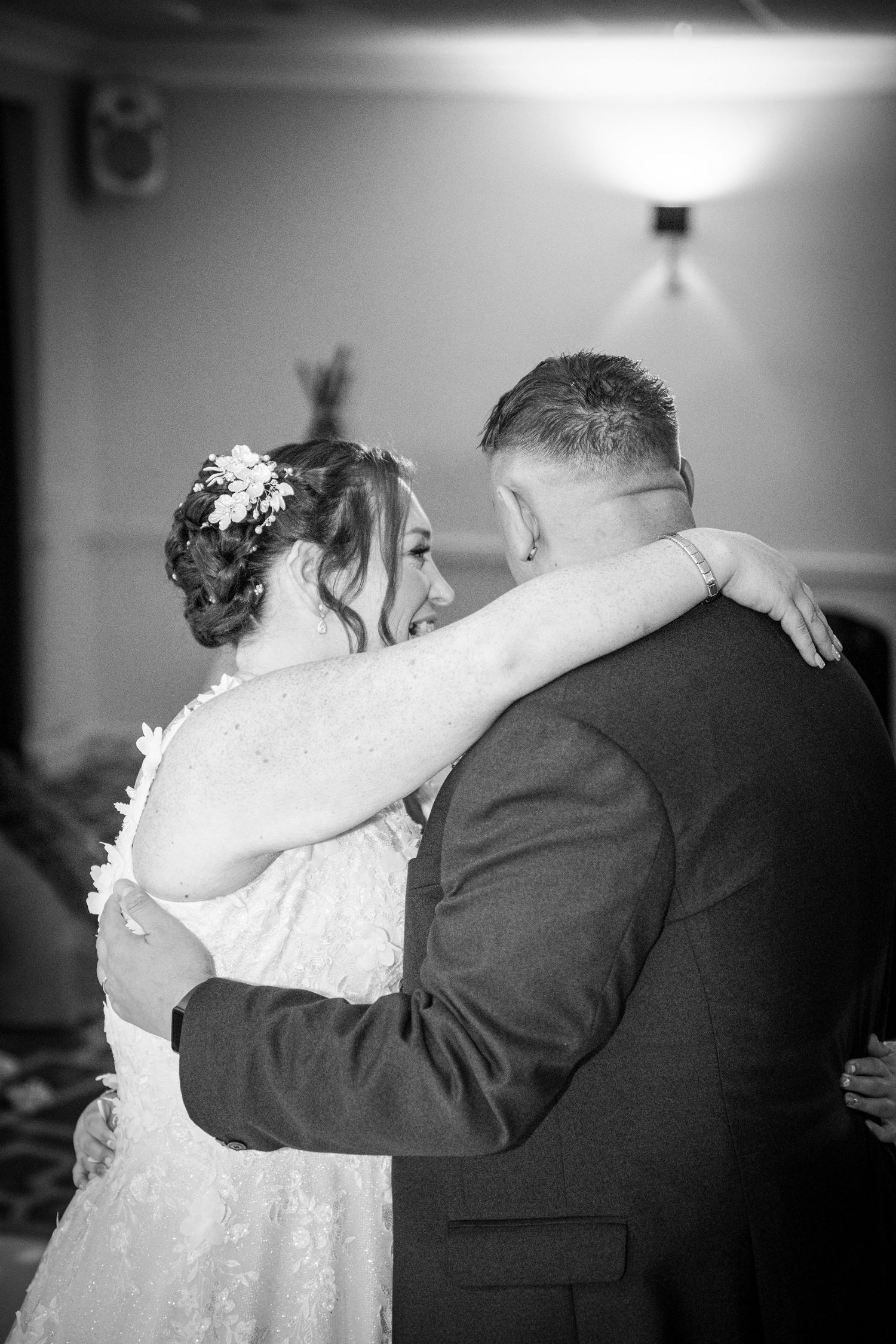 Black and white photo capturing an intimate dance moment at a wedding reception.