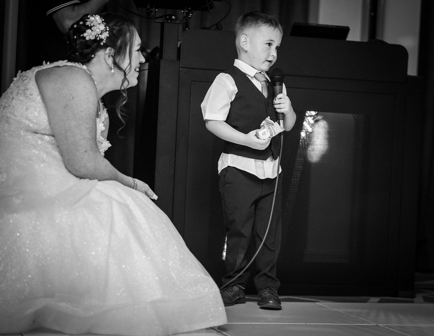 Black and white panoramic photo sequence showing dancers in elegant formal wear moving across a dance floor at an event.