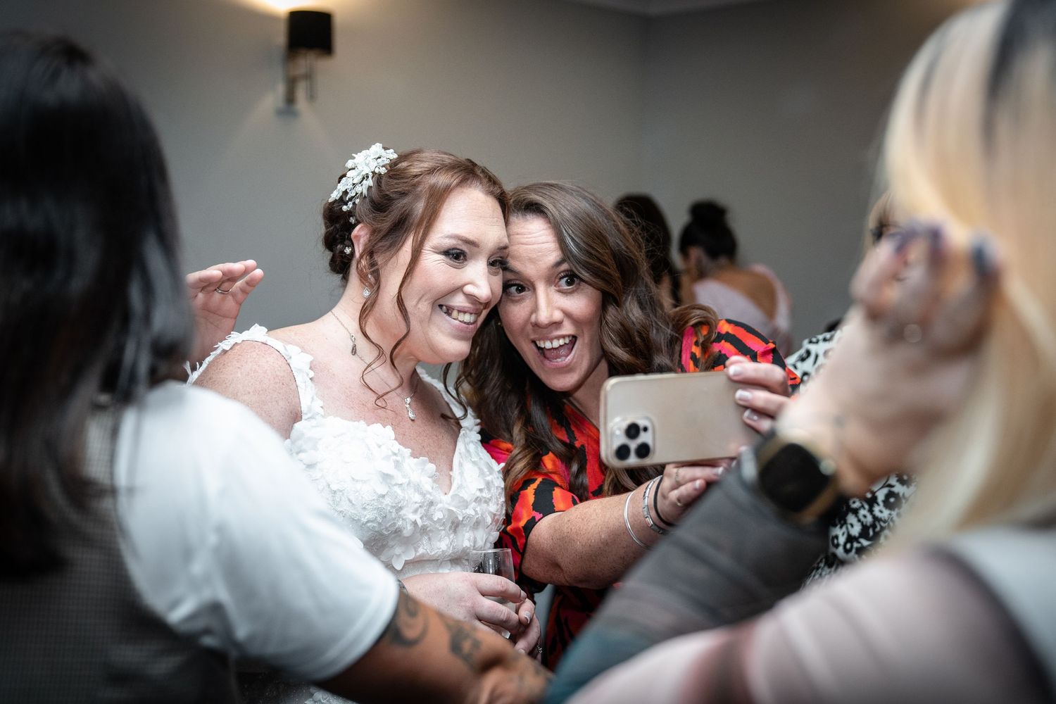 Wedding guests dancing and celebrating together on a dance floor during a reception.