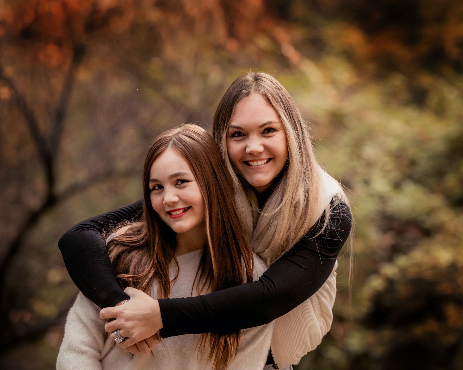 A series of candid outdoor portrait photos showing joyful moments and embraces against an autumn background.