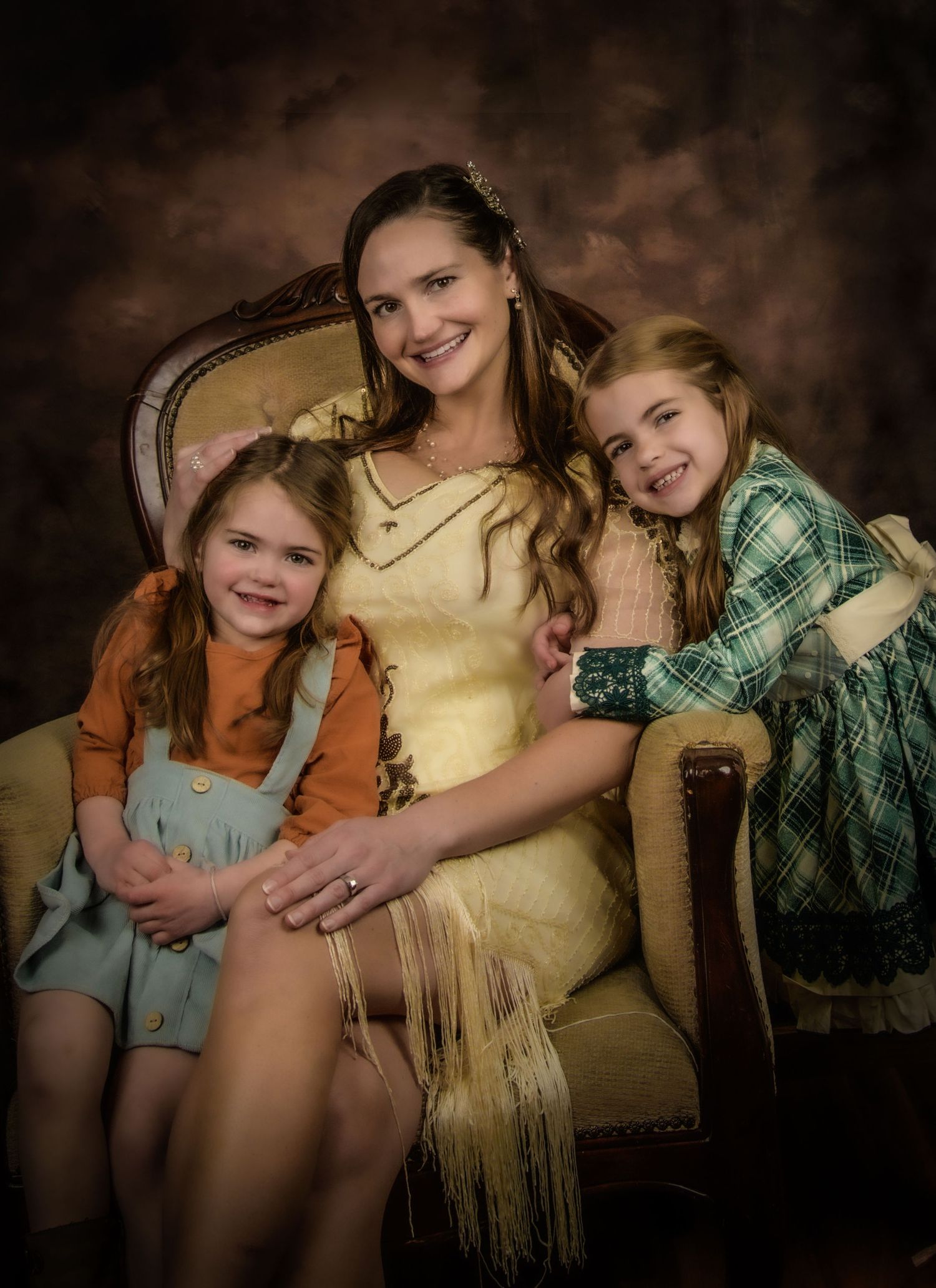 Heartwarming portrait session sequence showing siblings sitting together, captured in warm studio lighting against a dark background.