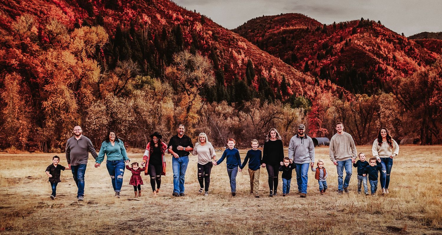 A series of panoramic photos showing a group walking together in a field with red-tinted mountains in the background.