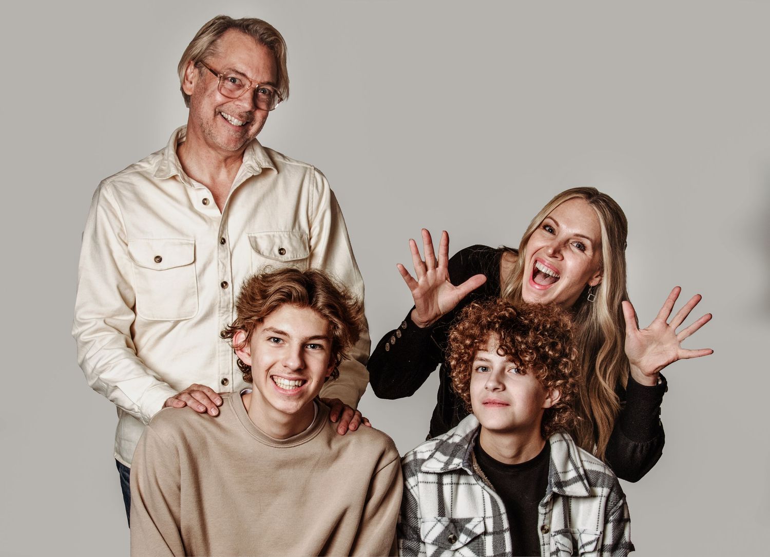 A series of five connected studio portraits showing people in casual attire posing playfully against a light background.