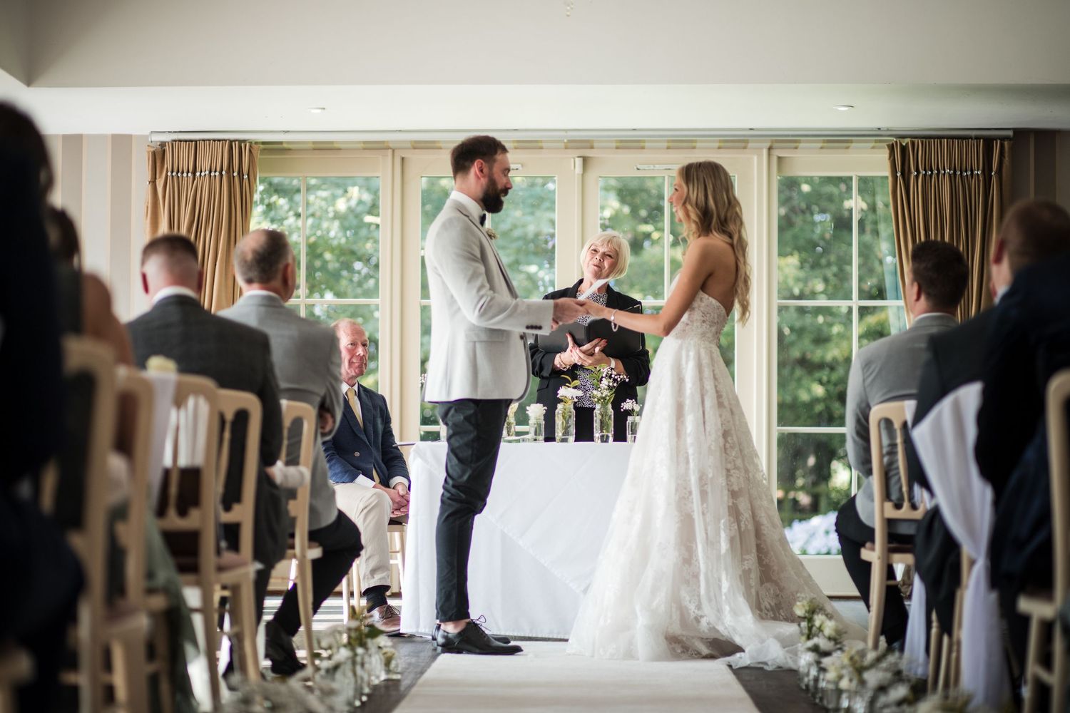 Kelham House bride and groom exchanging vows in the Garden Room filled with natural light