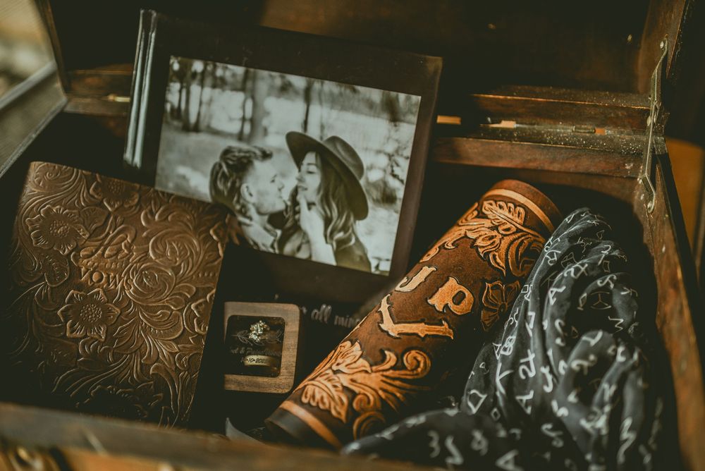 Close-up shot of intricately hand-tooled leather work showing detailed floral and scroll patterns Saskatchewan Wedding Photographer
