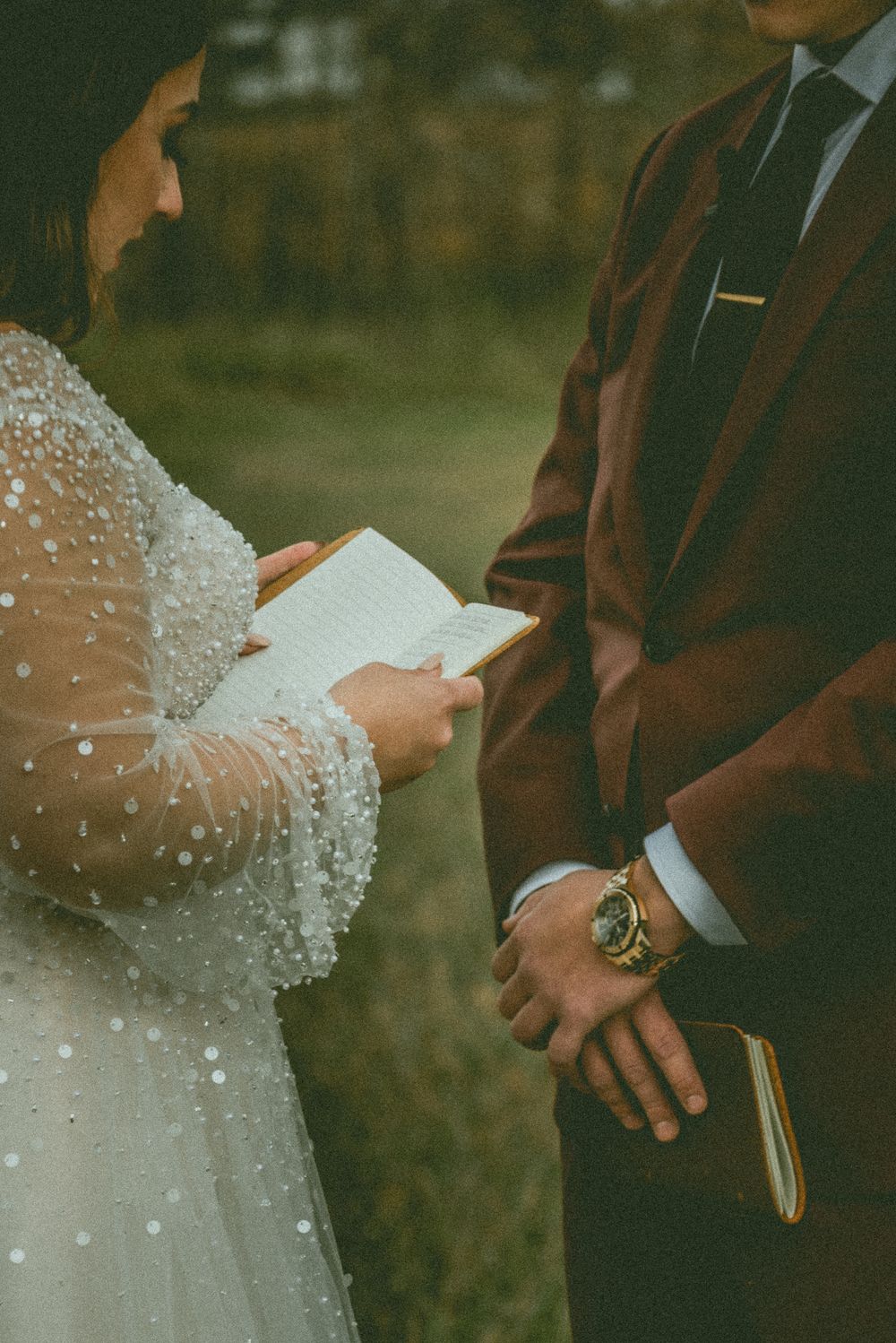 Couple in formal wedding attire standing close during intimate outdoor ceremony in warm sunlight. Saskatchewan Wedding Photographer
