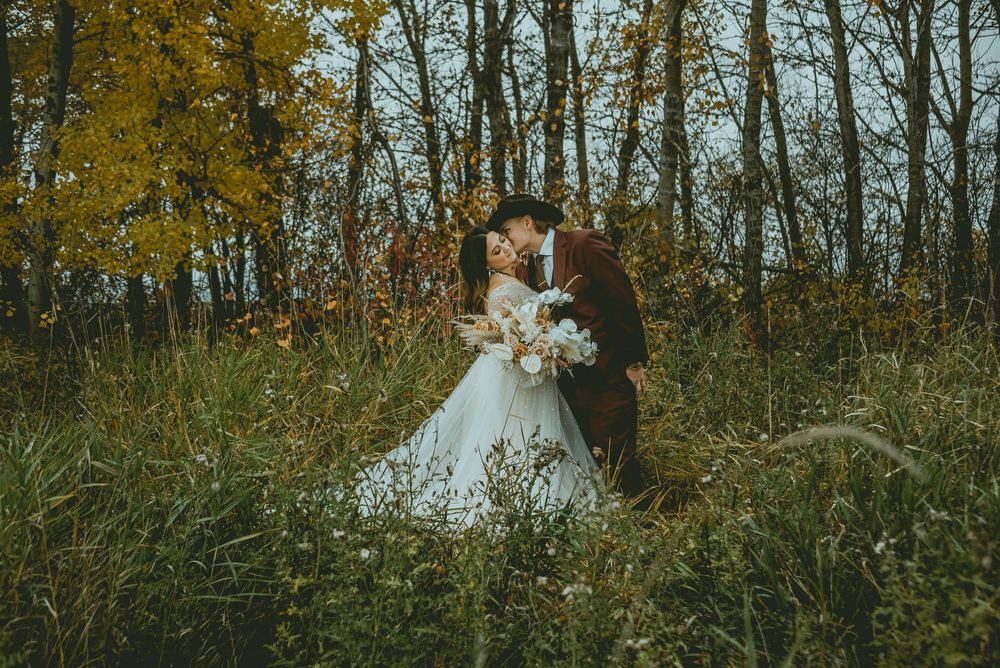 A serene outdoor photo session in an autumn forest setting with golden foliage and natural light Saskatchewan Wedding Photographer