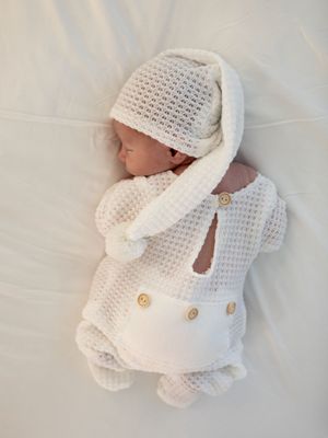 White knitted baby winter outfit with hat and cozy sweater displayed on white background from multiple angles.