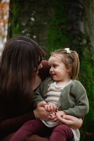 A tender moment captured in a series of photos showing a parent and child sharing playful interactions outdoors.