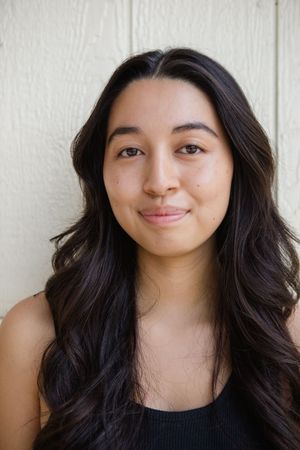 Portrait series showing dark-haired person in a black top against white wall with different expressions.