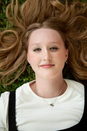 A series of portrait images showing someone lying down with flowing brown hair against a white background.
