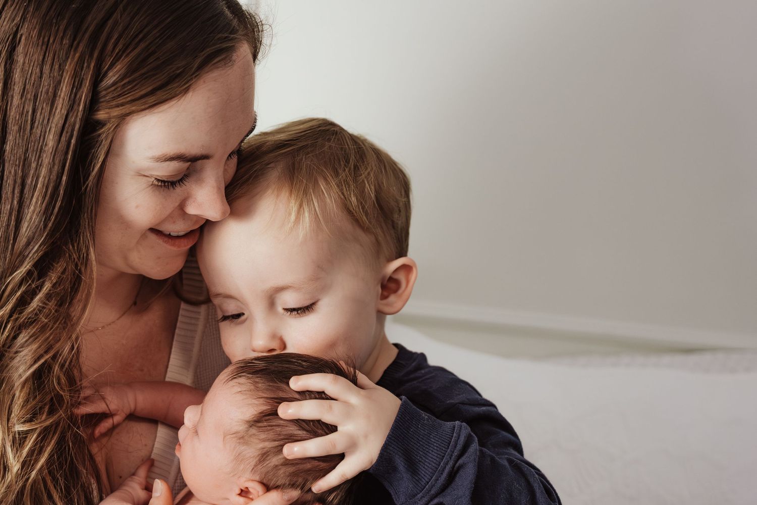 Mom, dad, and big brother snuggle with their new baby during their fresh 48 session