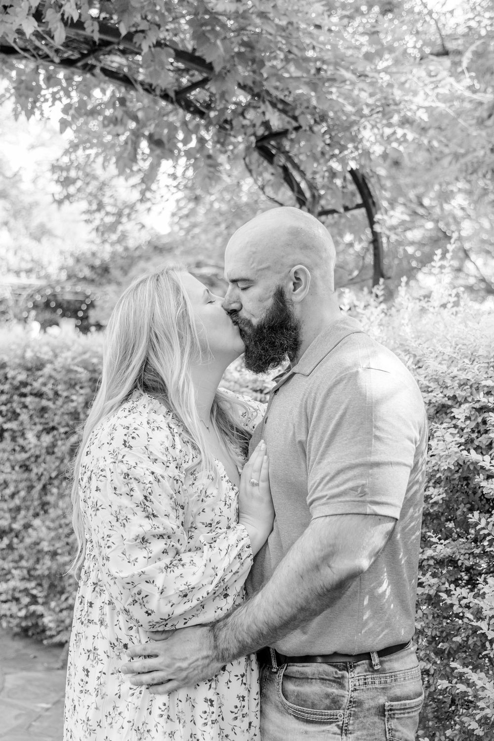 Groom-to-be proposing in a rose garden at the Botanical Gardens