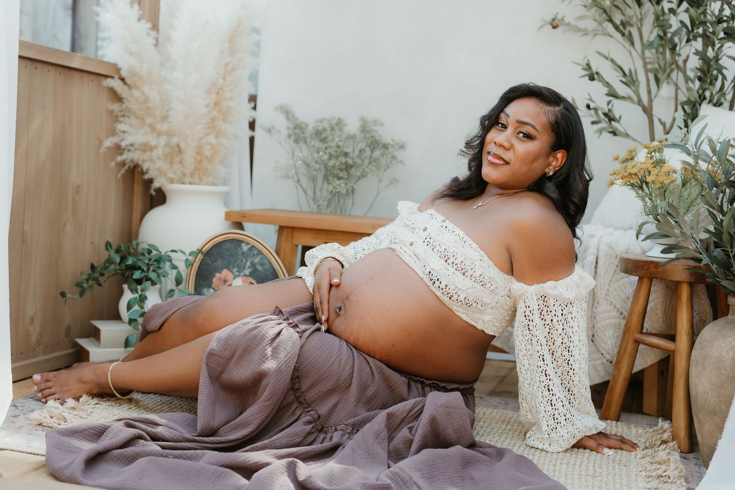 Romantic maternity portrait at Lake Cuyamaca with mom in boho black dress and tan hat. San Diego maternity photographer