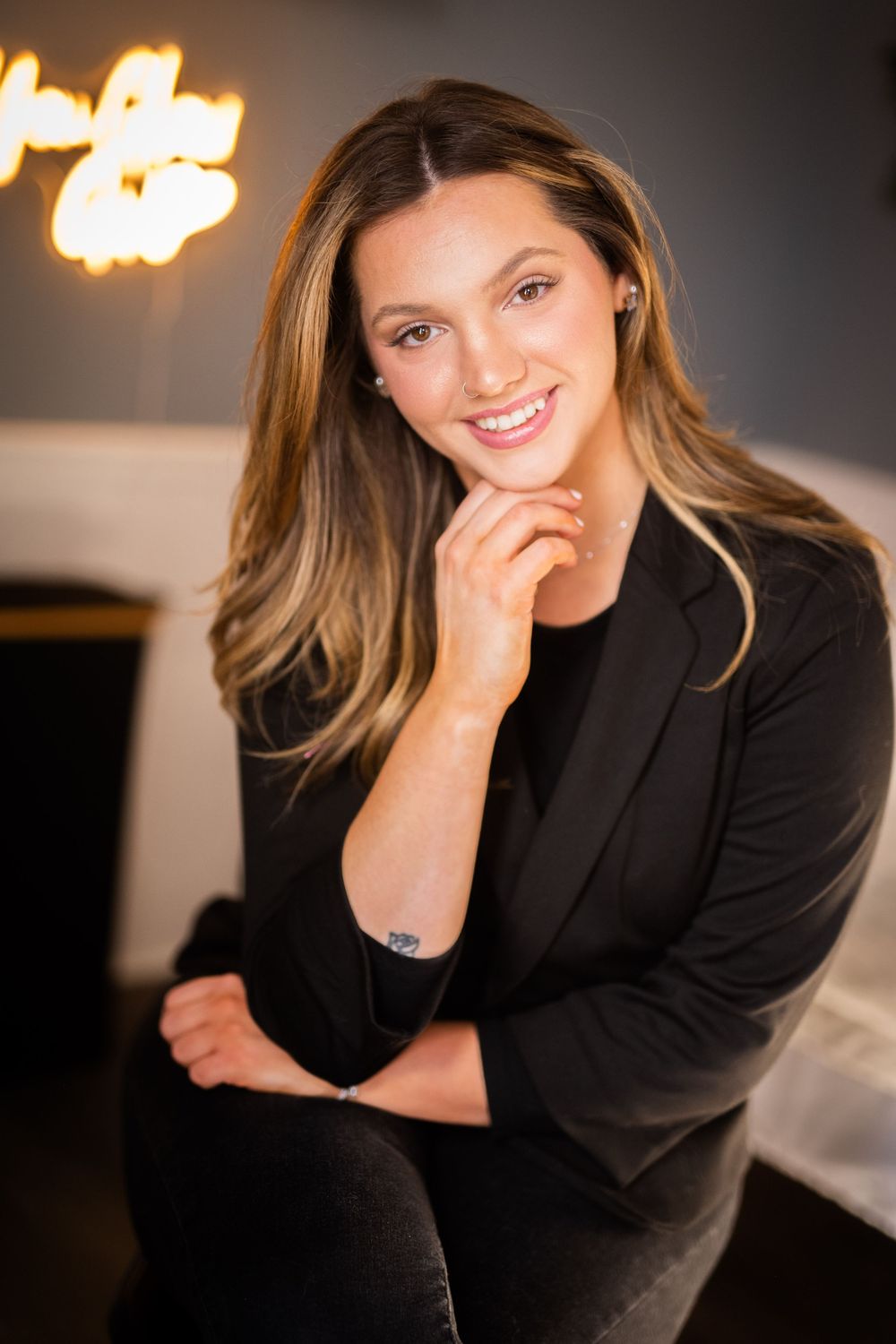 Professional headshots featuring warm lighting and a dark background with dramatic shadows.