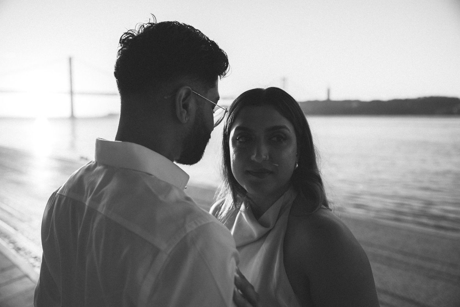 Cinematic close-up of couple with the Tagus River in the background. captured by a portugal wedding photographer
