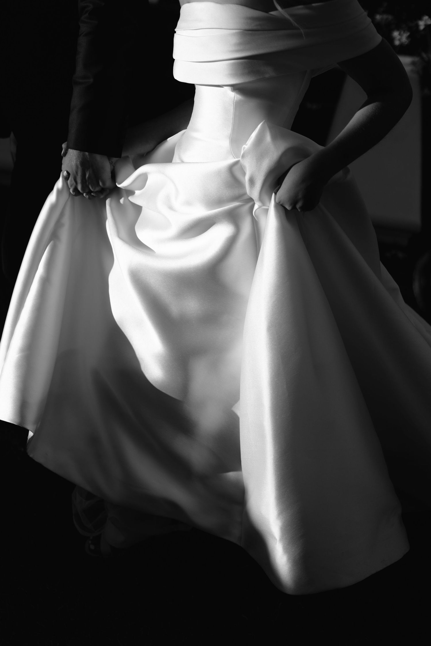 Black and white artistic close-up shots of flowing white fabric with elegant draping and folds creating dramatic shadows.