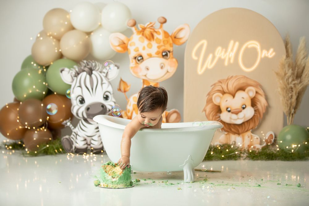 Cake smash bath photoshoot Brisbane western suburbs – one-year-old baby boy in white tub.