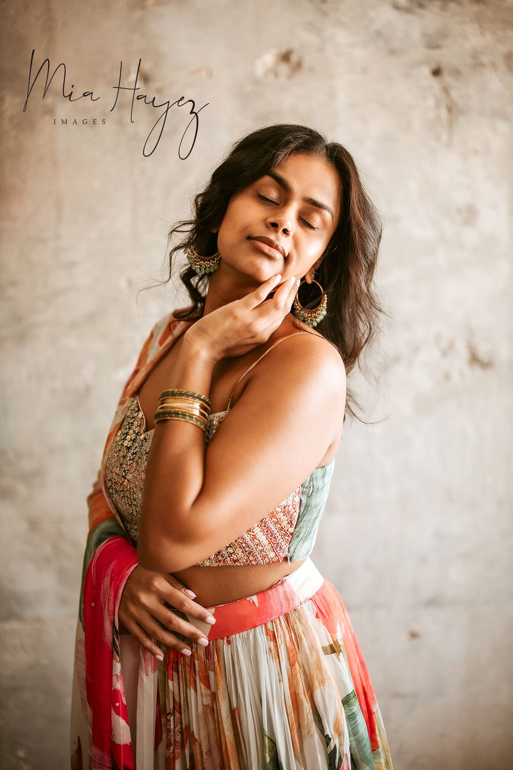 Artistic portrait series showing expressive poses in a colorful flowing dress against a textured wall.