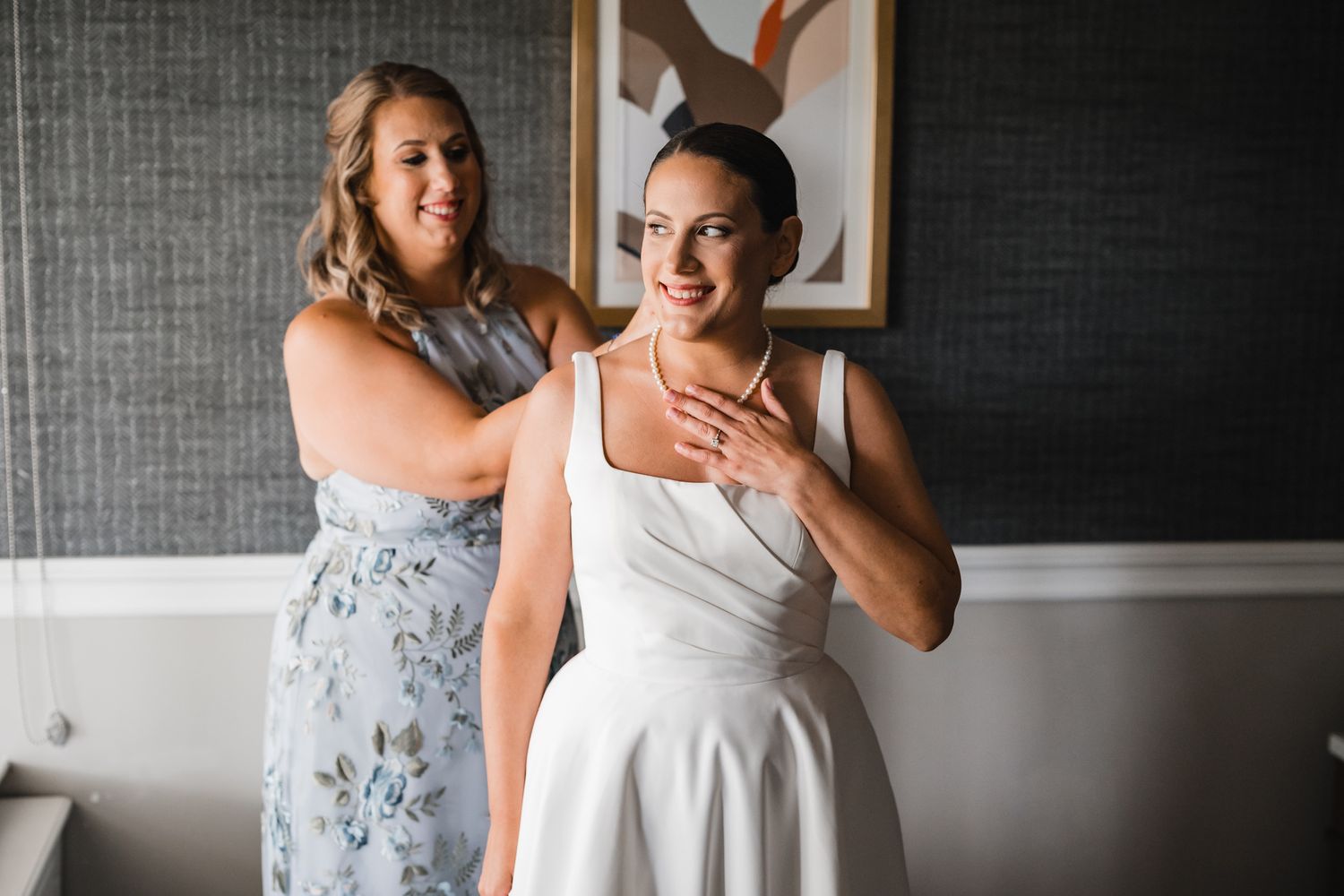 A touching moment shared during wedding preparations in a room with modern decor.