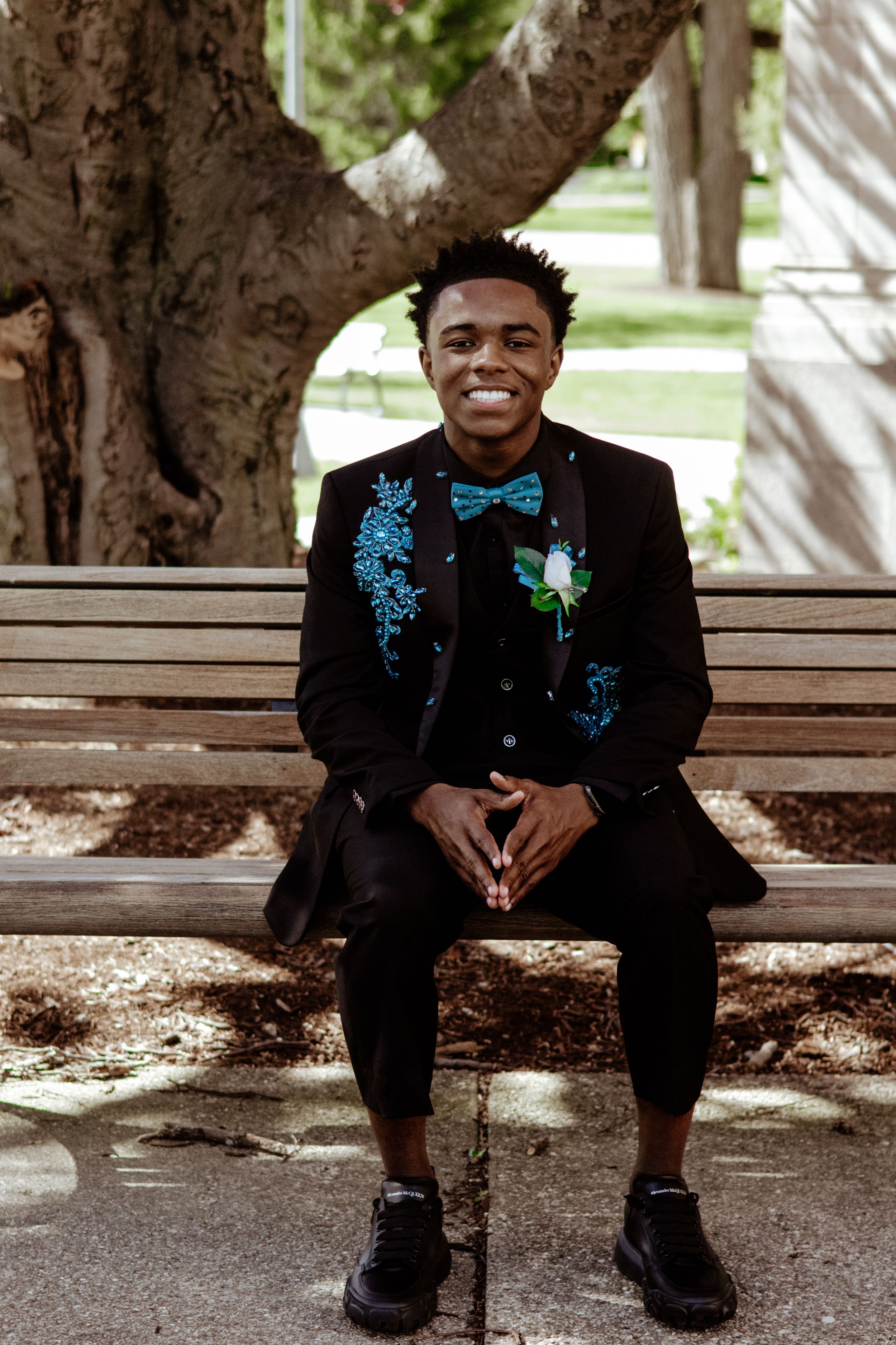 A senior in high school posing for prom pictures.