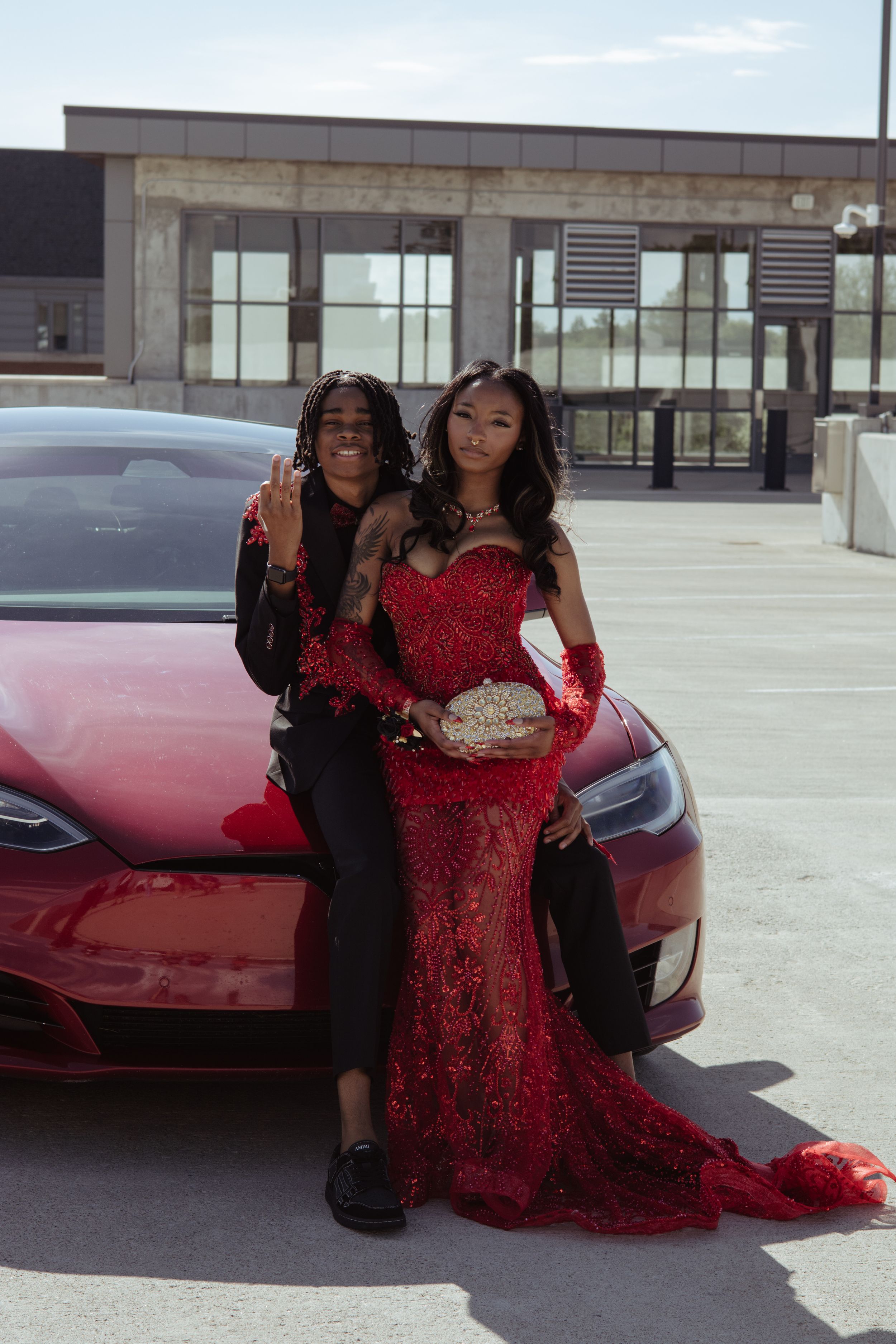 Two seniors in high school posing for prom pictures.