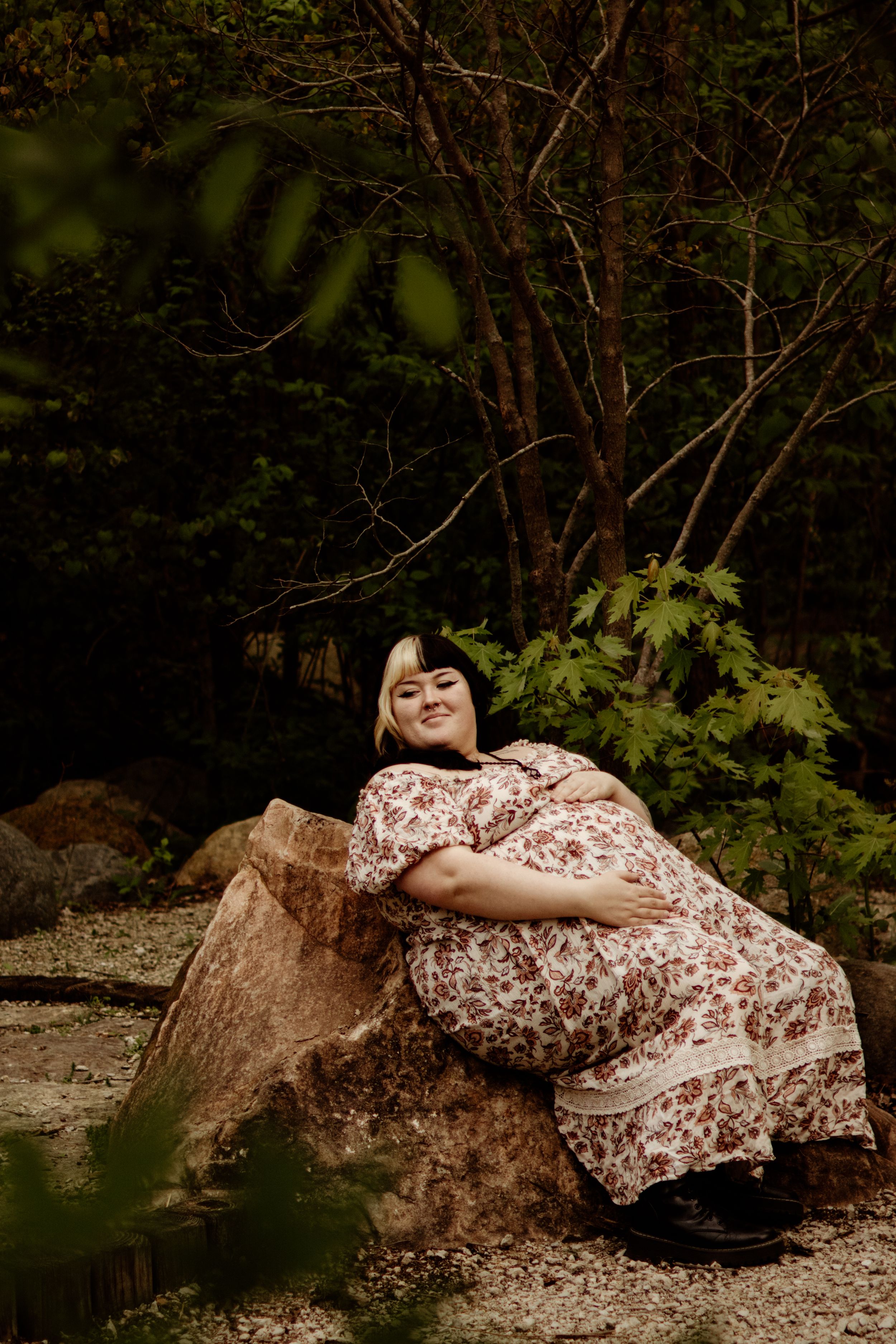 young mom posing in woods.