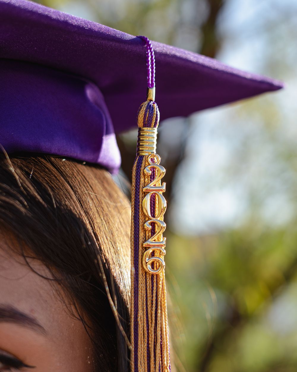 Close-up of a purple graduation cap with a gold 2026 tassel worn by a student at a graduation ceremony.