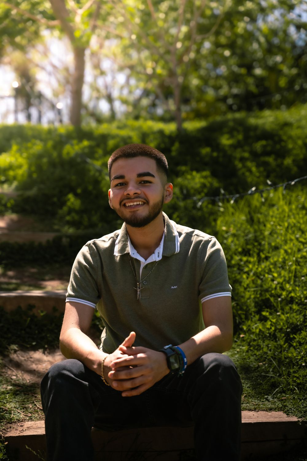 Casual outdoor portrait session in a lush garden setting.