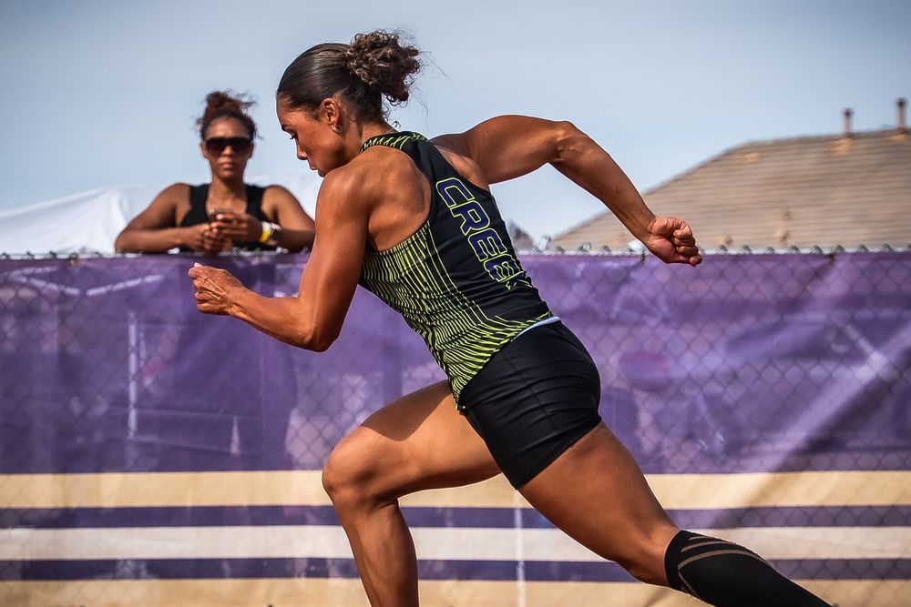 Athletes perform dynamic track and field jumps on a purple running track.