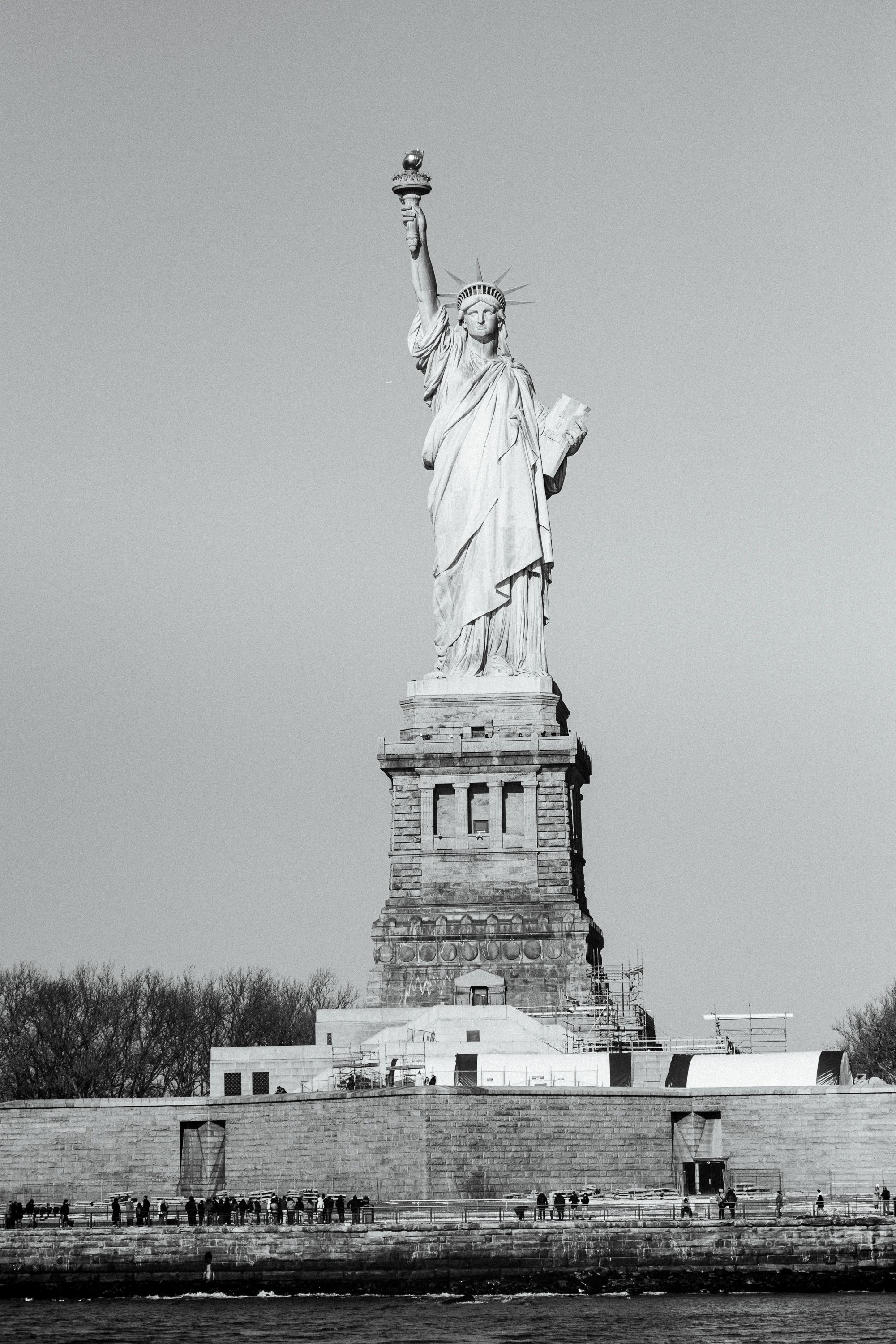 Black and white panoramic sequence showing the Statue of Liberty from different angles.