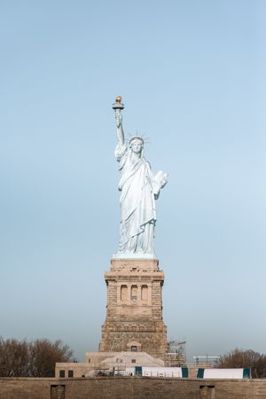 Sequential photos showing different angles of the Statue of Liberty on Liberty Island.