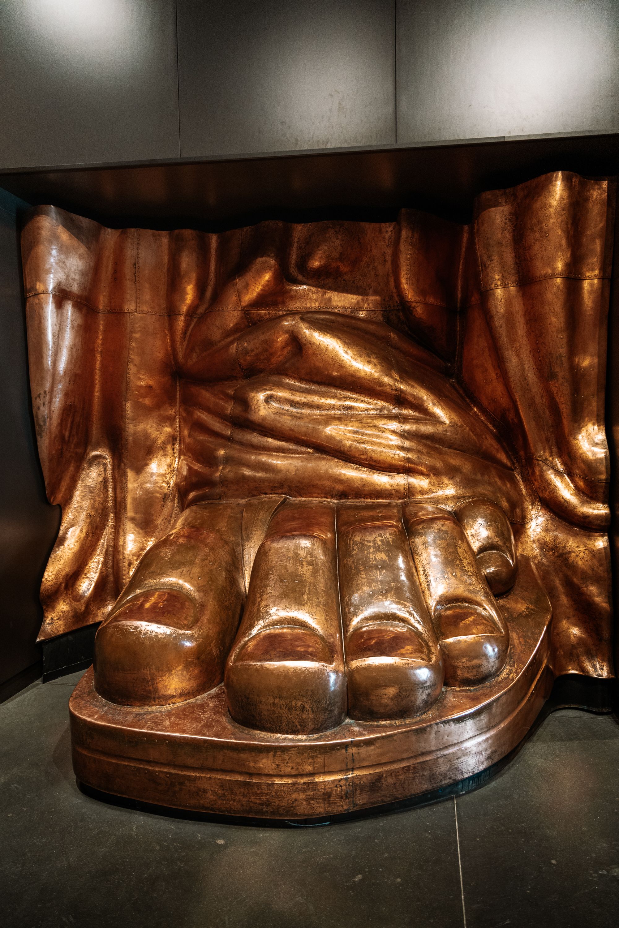 Close-up sequence of the copper-colored feet and sandals from the Statue of Liberty.