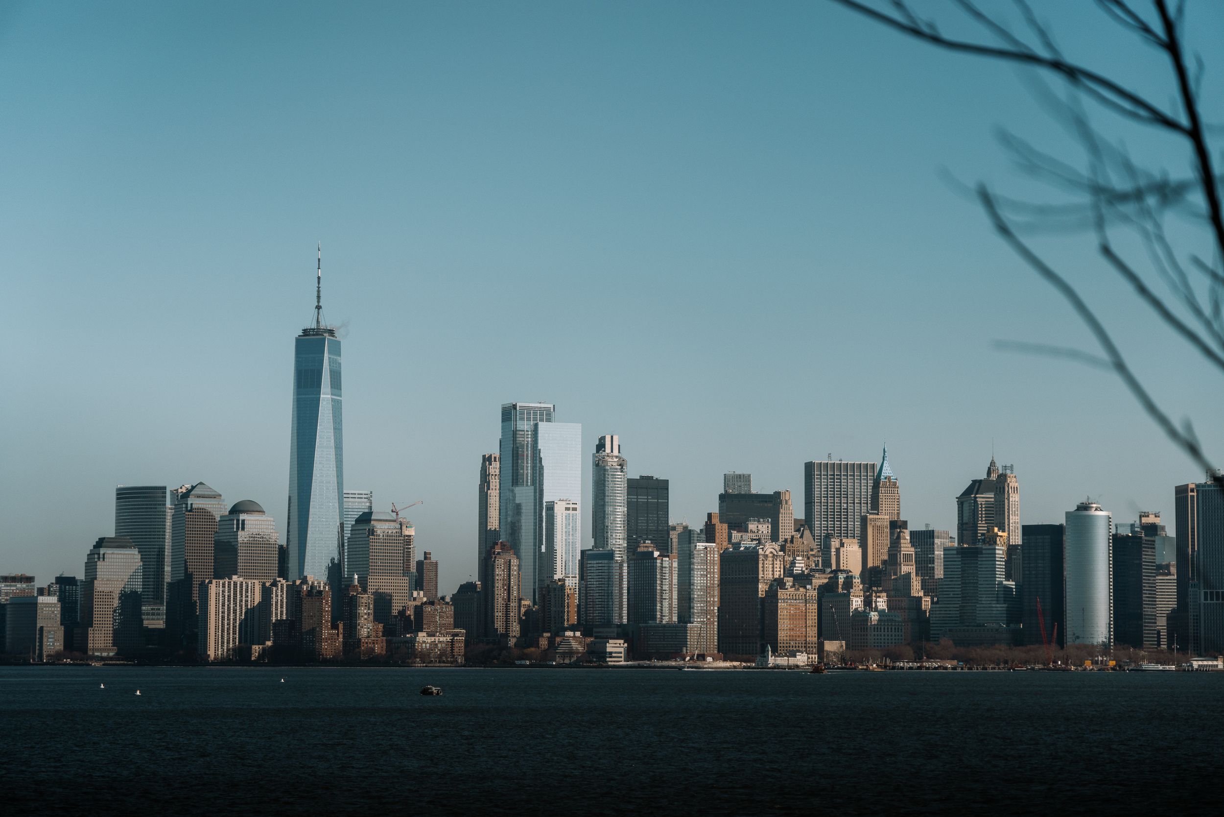 Manhattan skyline silhouette viewed from Liberty Island on a clear winter day.