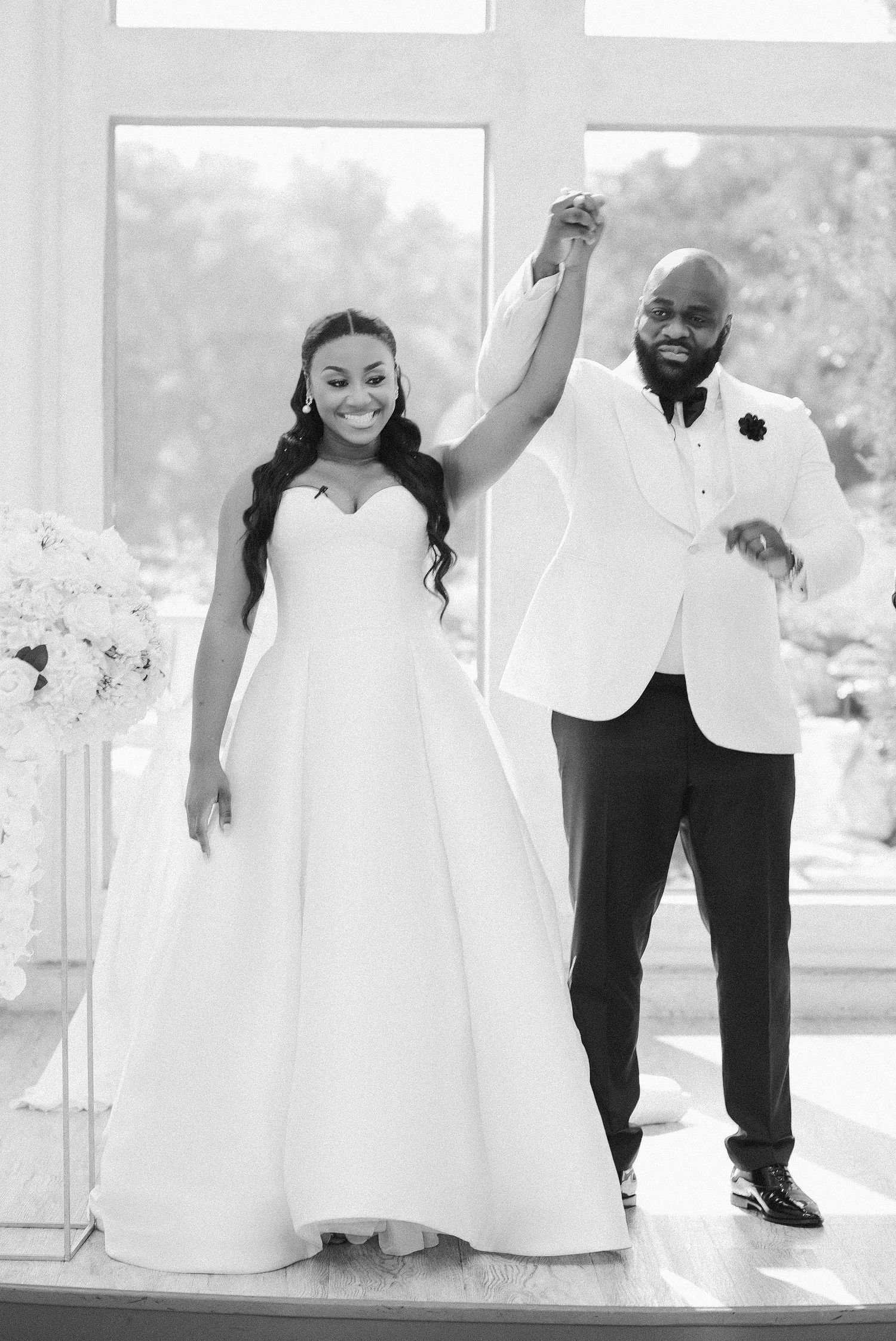 A series of black and white wedding photos showing playful moments between a couple in formal attire.