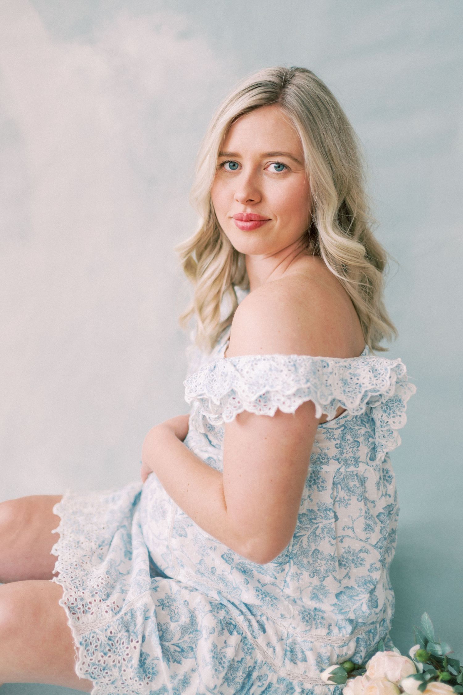 A series of soft, romantic photos showing a delicate blue and white lace dress against a light blue background.